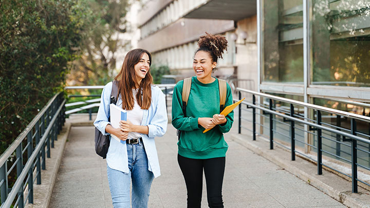 Female university students walking out of school building